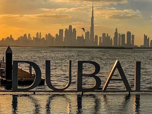 Stunning Dubai skyline with Burj Khalifa at sunset across the waterfront